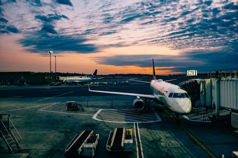 Aircraft at an airport apron at sunset