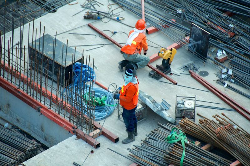 Workers in safety gear on a reinforced-concrete construction deck